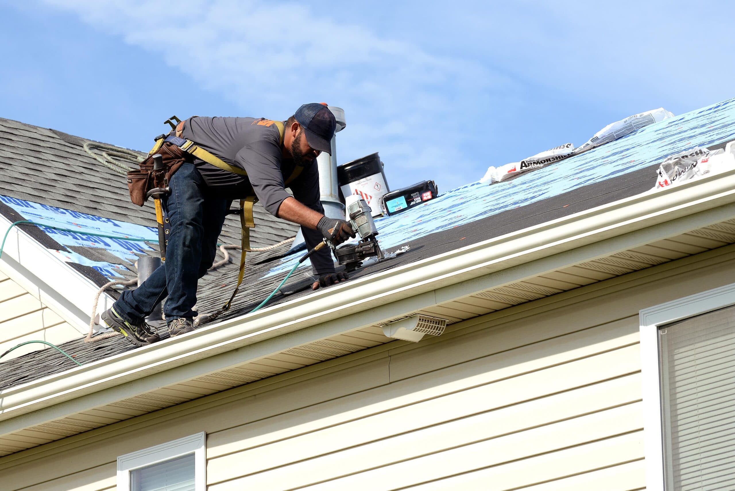 A roofing professional documenting roof conditions after choosing to join the NRCIA