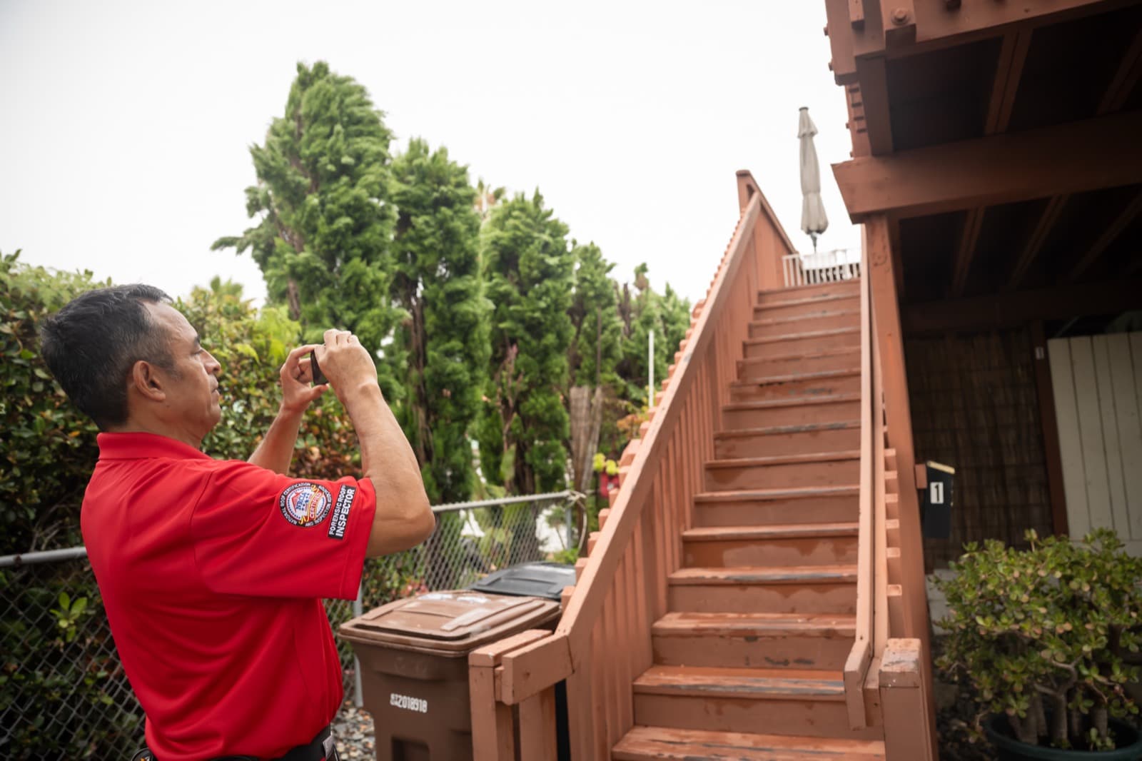 Inspector examining an apartment balcony during an SB 721 compliance inspection