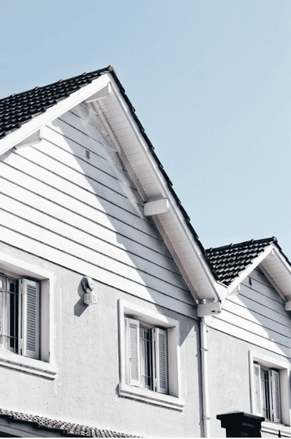 Light-colored reflective roof on a residential home under bright sun