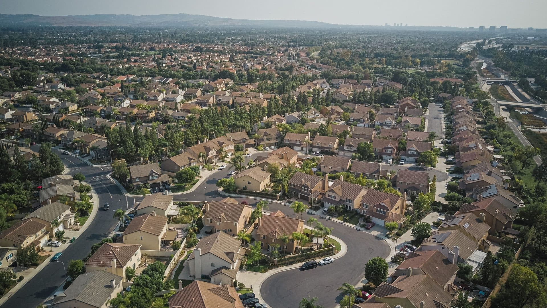 Aerial view of a planned community of tile-roofed homes