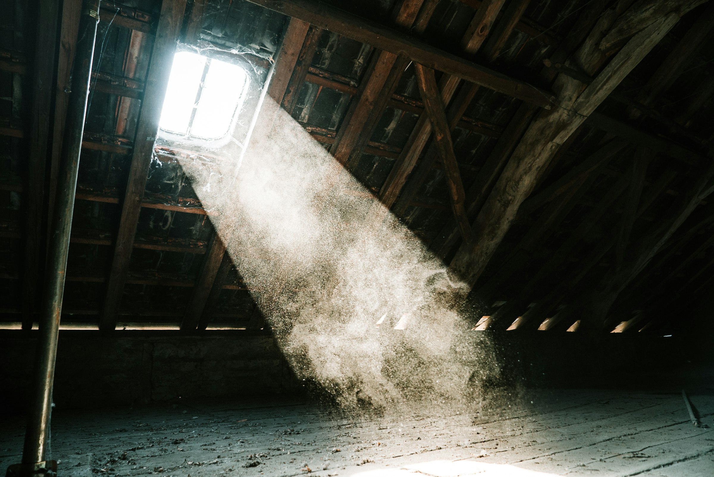 Sunlight falling through a gap into a dark attic