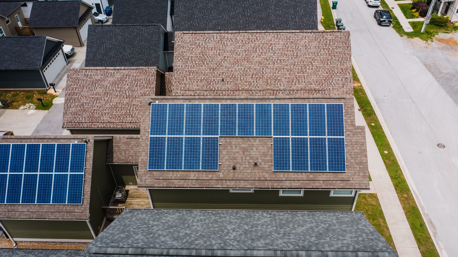 Aerial view of a finished solar panel array on a shingle roof